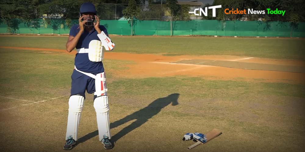 cricketer waring cricket guards standing in a ground